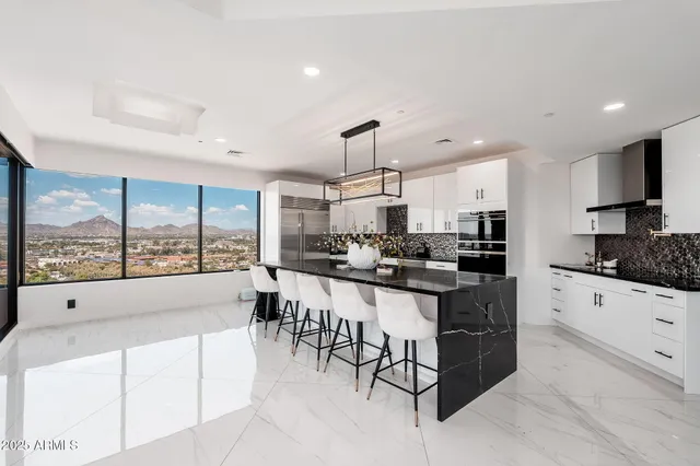 a kitchen with counter top space view and living room view