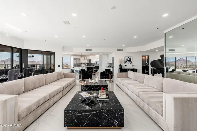 a kitchen with granite countertop a refrigerator and a stove top oven