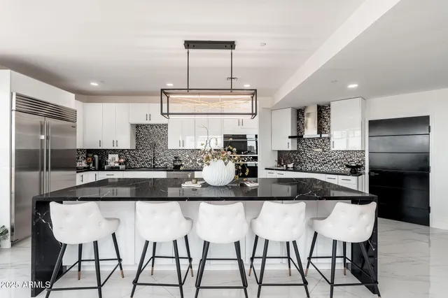 a kitchen with a sink a stove and cabinets