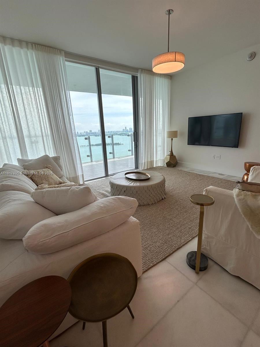 700 Northeast 26th Terrace, Unit 2602 Miami, FL 33137 - Photo 12 of 38 a living room with furniture and a flat screen tv