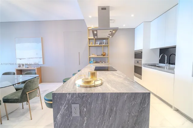 a kitchen with kitchen island sink stove and center island