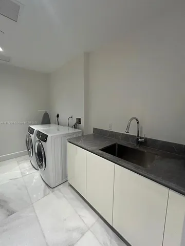 a kitchen with a sink and cabinets