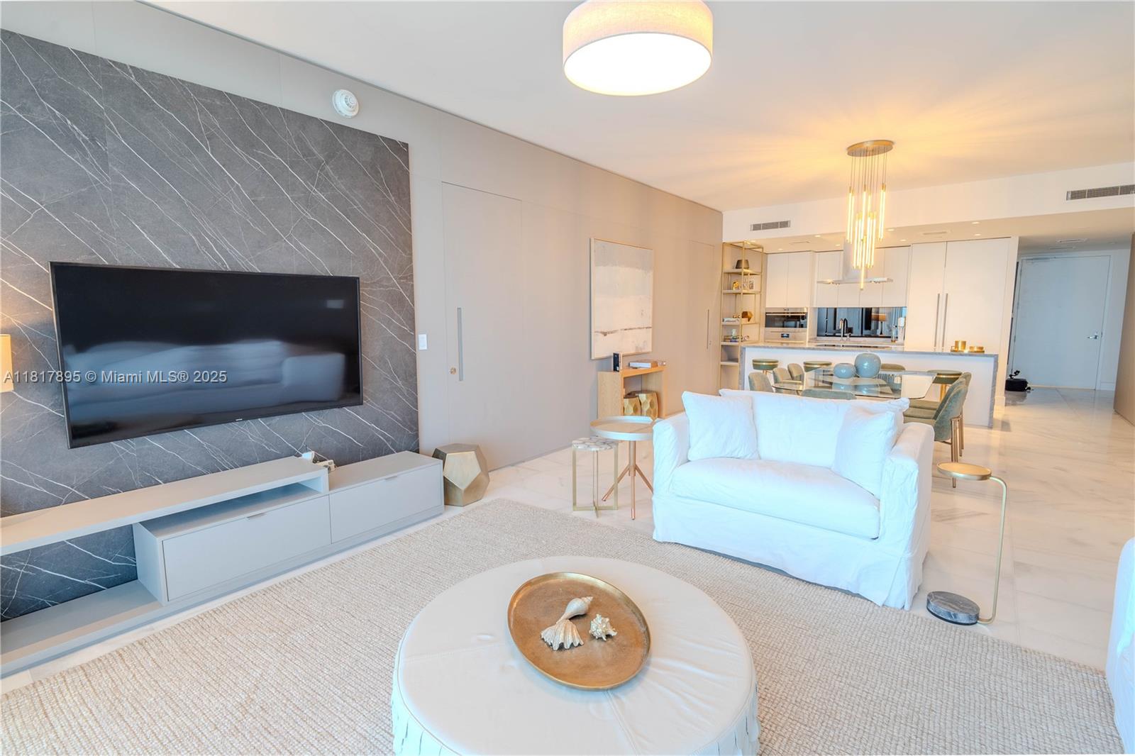 700 Northeast 26th Terrace, Unit 2602 Miami, FL 33137 - Photo 17 of 38 a living room with furniture and a fireplace