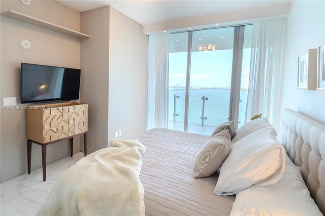a bedroom with a bed and flat screen tv