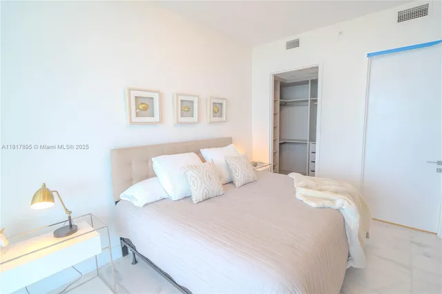 a bedroom with a bed and a couch