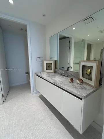 a bathroom with a double vanity sink and a mirror