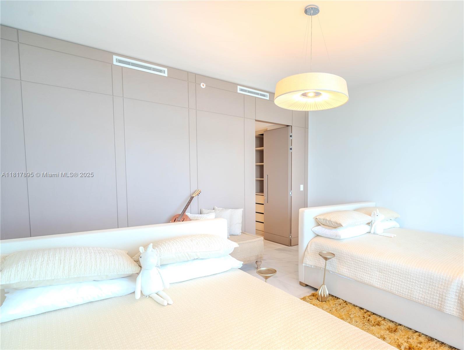 700 Northeast 26th Terrace, Unit 2602 Miami, FL 33137 - Photo 27 of 38 a bedroom with a bed and a chandelier