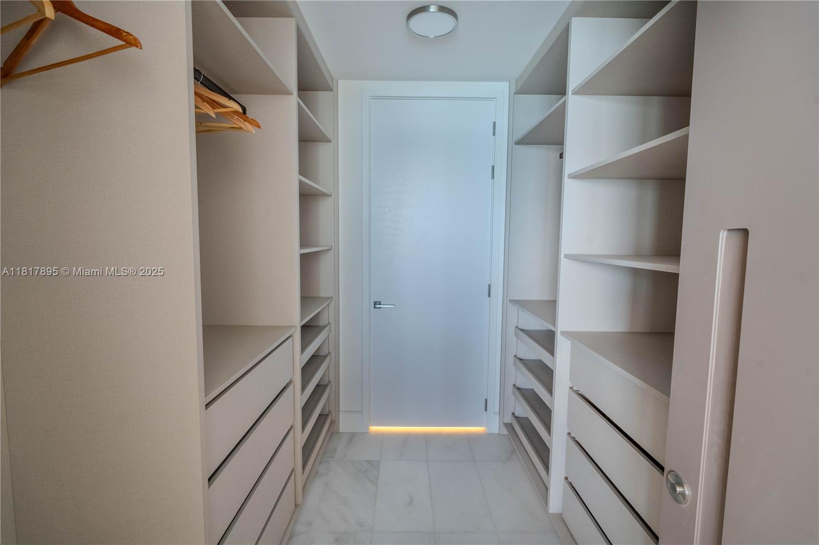 700 Northeast 26th Terrace, Unit 2602 Miami, FL 33137 - Photo 29 of 38 a view of walk in closet with empty racks