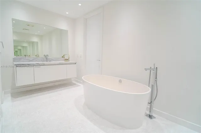 a white bath tub sitting in a bathroom