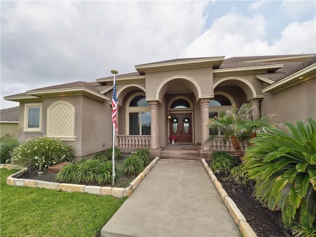 a front view of a house with garden