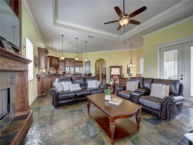 a living room with furniture fireplace and a chandelier