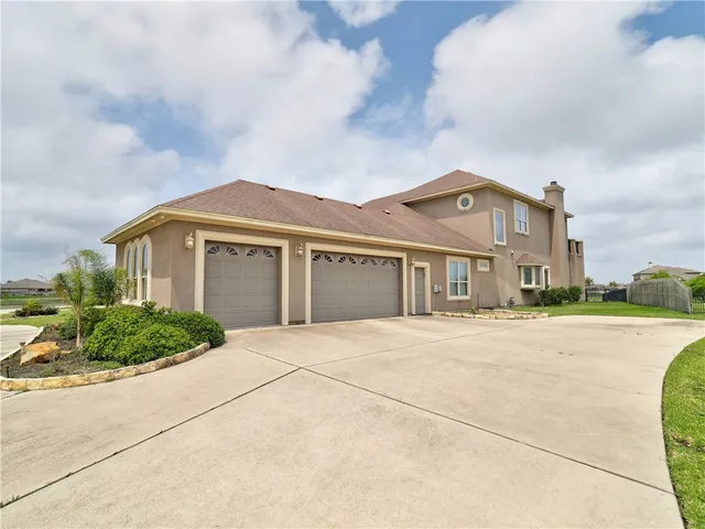 a front view of a house with a garden and pathway