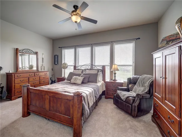 a bedroom with a bed couch and window