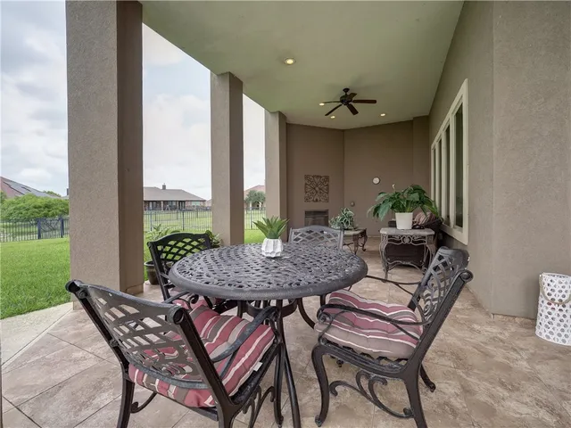 a view of a patio with swimming pool table and chairs