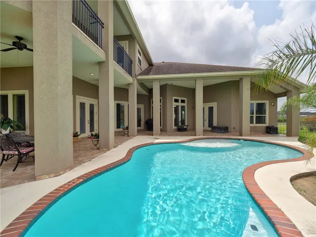 a view of a swimming pool with a yard