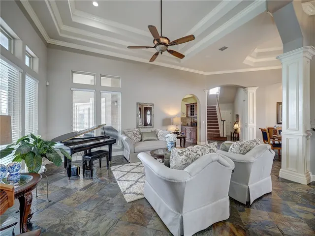 a living room with furniture a table and a potted plant