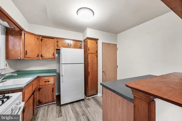 a kitchen with stainless steel appliances a refrigerator and a stove