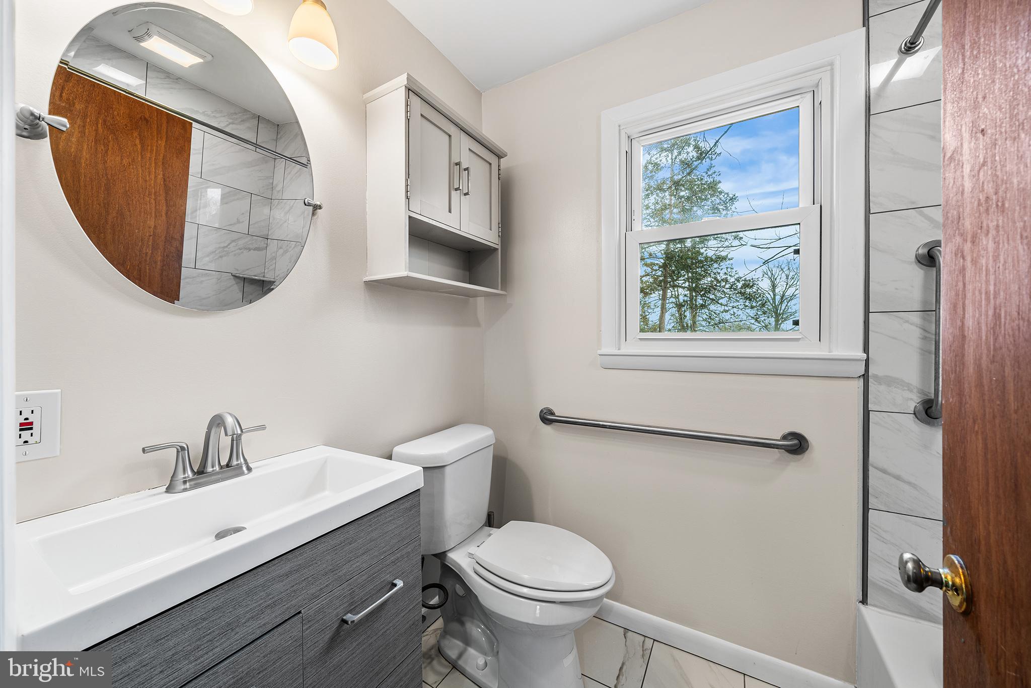 1108 Providence Road Secane, PA 19018 - Photo 19 of 33 a bathroom with a toilet sink and mirror