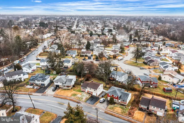 an aerial view of a residential apartment building with parking
