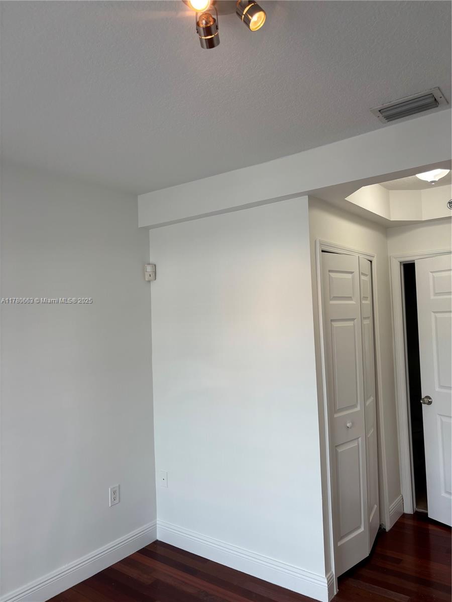 2415 Northwest 16th St Road, Unit 103 Miami, FL 33125 - Photo 18 of 42 wooden floor in an empty room