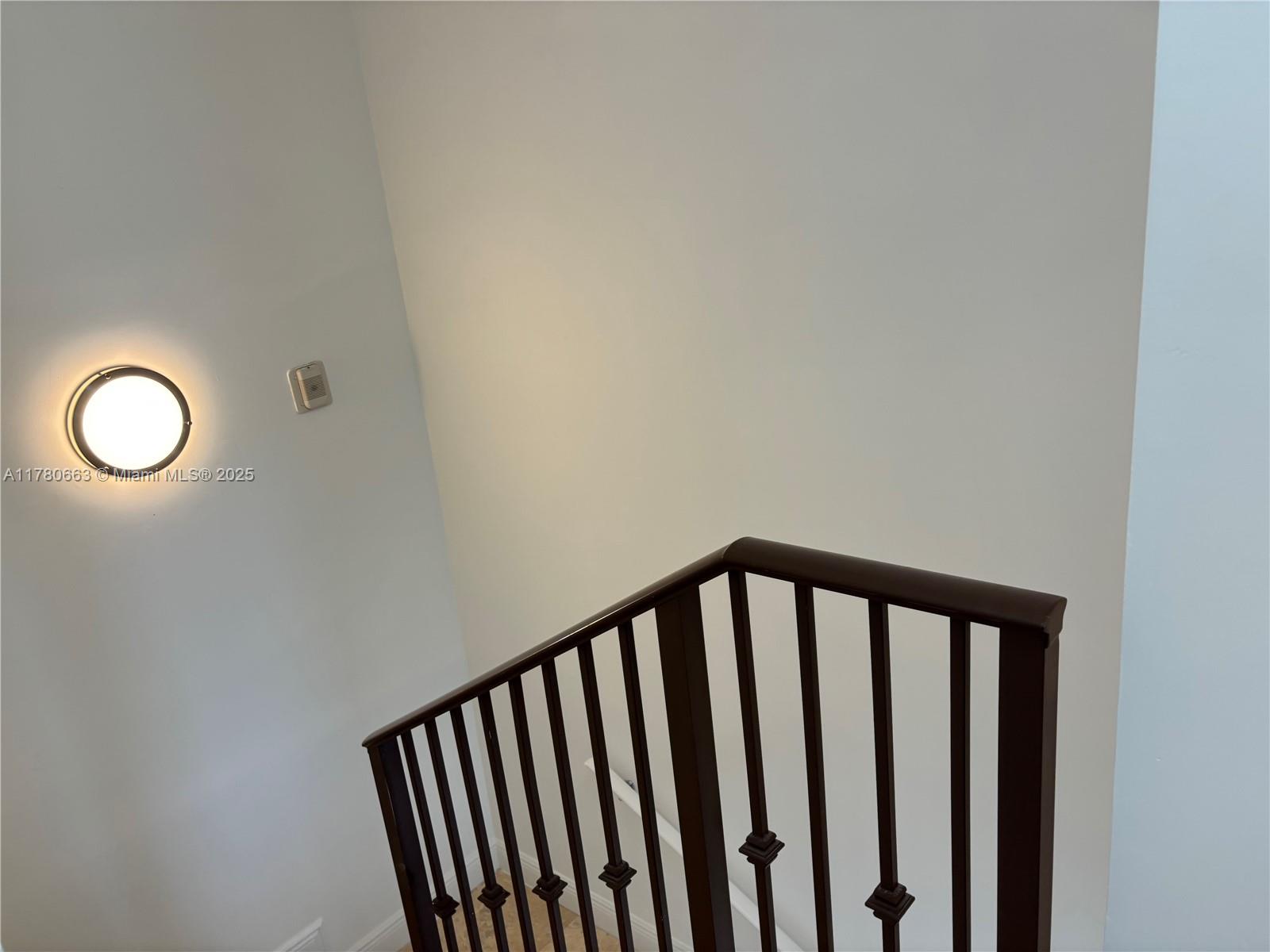 2415 Northwest 16th St Road, Unit 103 Miami, FL 33125 - Photo 24 of 42 a view of staircase with rug