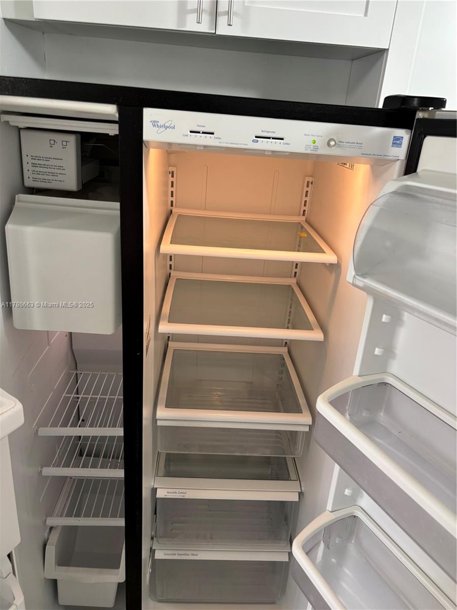 2415 Northwest 16th St Road, Unit 103 Miami, FL 33125 - Photo 8 of 42 a view of walk in closet with empty racks