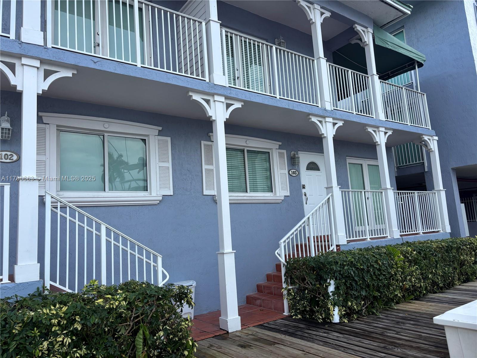 2415 Northwest 16th St Road, Unit 103 Miami, FL 33125 - Photo 10 of 42 a view of a house with wooden fence