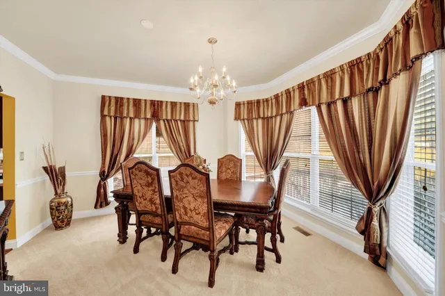 a view of a dining room with furniture and window