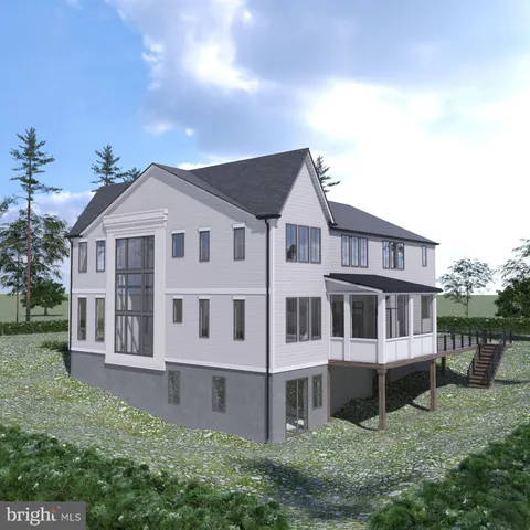 a view of residential houses with yard and trees