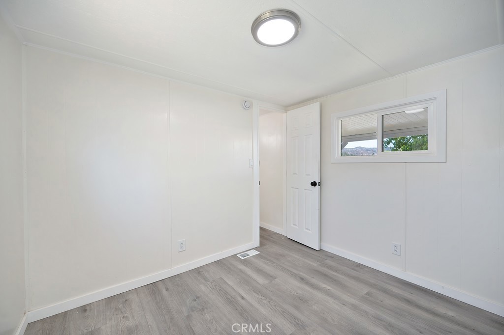 26455 Paradise Valley Road, Unit 86 Warner Springs, CA 92086 - Photo 27 of 34 an empty room with wooden floor and window