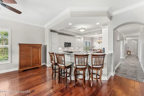 a dining room with furniture and wooden floor