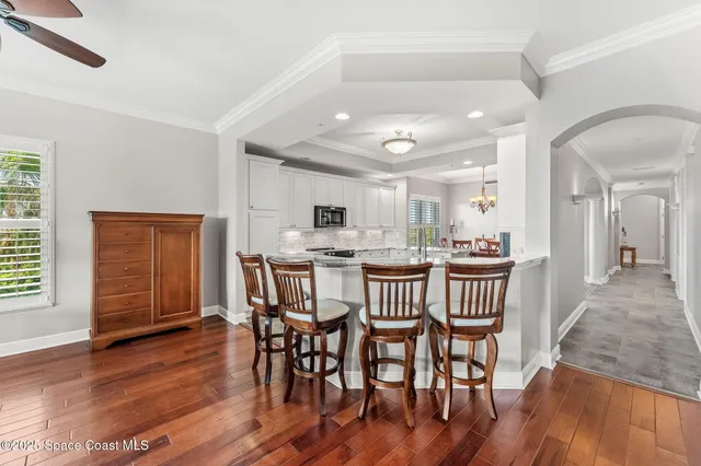 a dining room with furniture and wooden floor