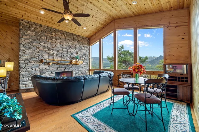 a living room with furniture a ceiling fan and a rug