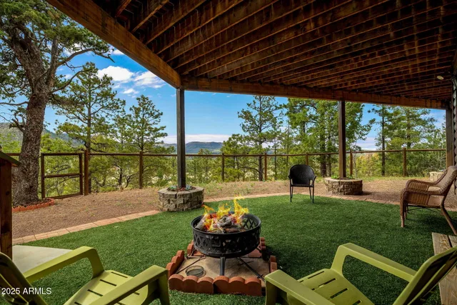 a view of balcony with chairs and wooden fence