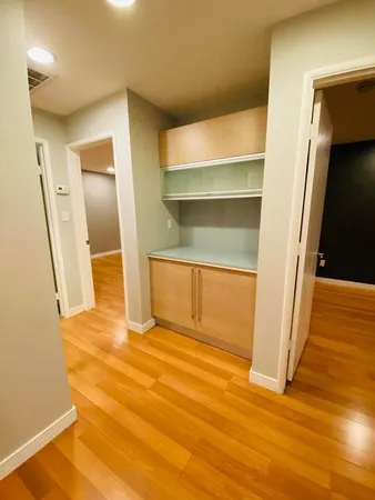 a view of empty room with wooden floor