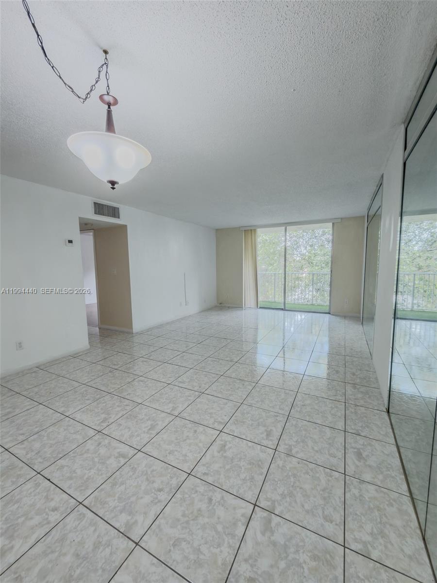 8411 Northwest 8th Street, Unit 301 Miami, FL 33126 - Photo 1 of 15 a view of an empty room with a window