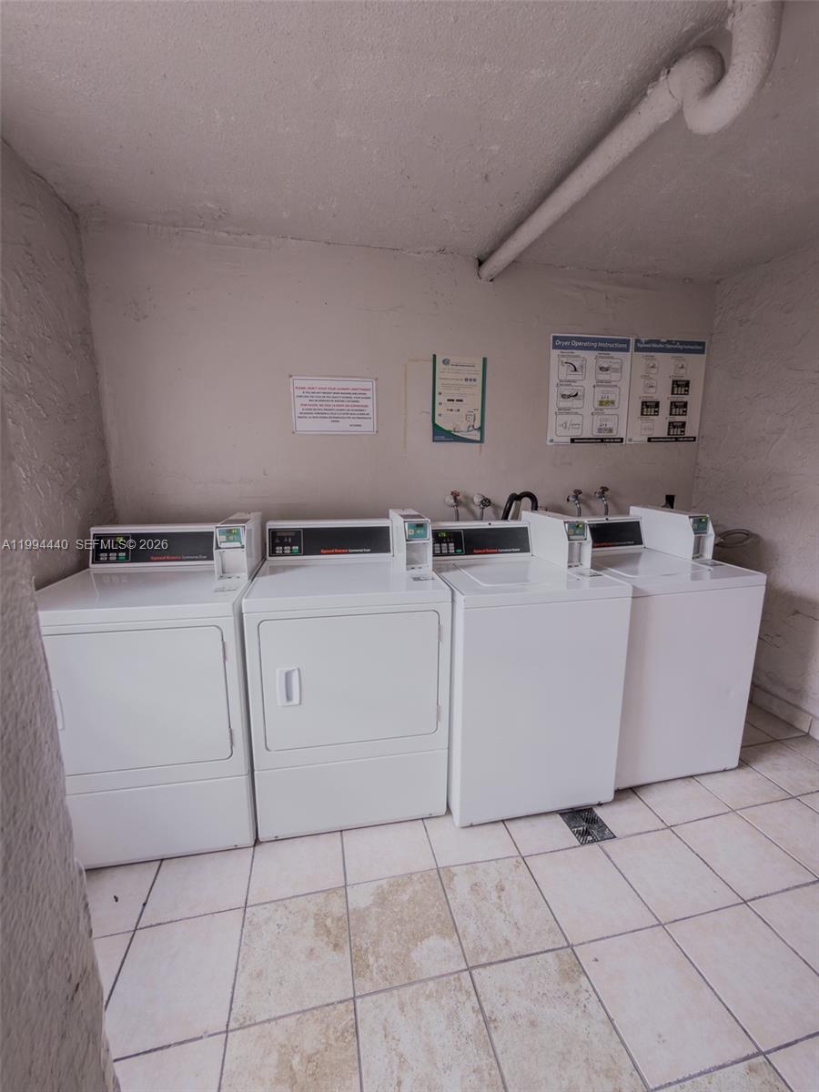 8411 Northwest 8th Street, Unit 301 Miami, FL 33126 - Photo 12 of 15 a utility room with dryer and washer