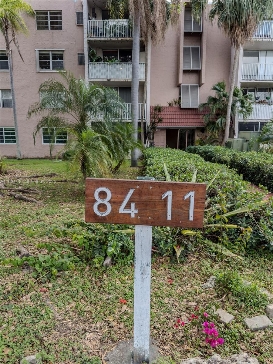 8411 Northwest 8th Street, Unit 301 Miami, FL 33126 - Photo 2 of 15 a sign that is sitting in front of a brick house