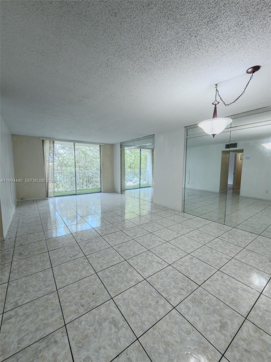 8411 Northwest 8th Street, Unit 301 Miami, FL 33126 - Photo 3 of 15 a view of an empty room and window