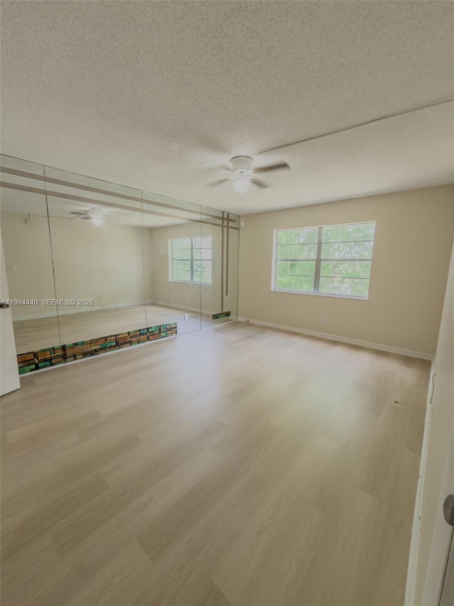 8411 Northwest 8th Street, Unit 301 Miami, FL 33126 - Photo 6 of 15 an empty room with an empty space and windows