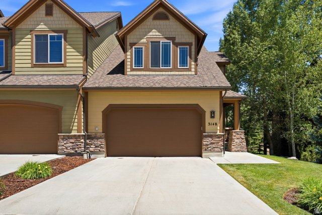 3148 Lower Saddleback Road Park City, UT 84098 - Photo 4 of 67 Exterior features include a two-car garage, stone facade accents, a covered entry, and dormer windows