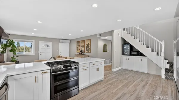 a kitchen with a stove a sink and a refrigerator