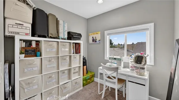 a room with furniture a rug and white walls