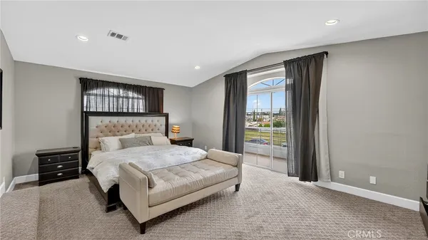 a bedroom with a large bed and a window