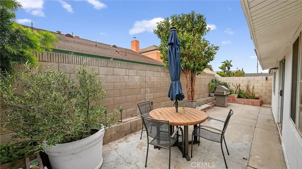 a view of a patio with table and chairs and potted plants