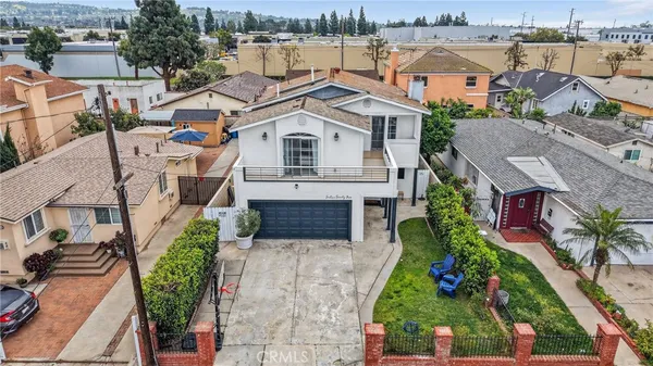 an aerial view of multiple houses with a yard