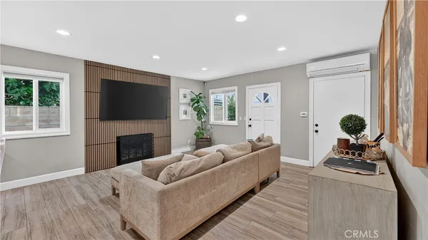 a living room with furniture a fireplace and a flat screen tv