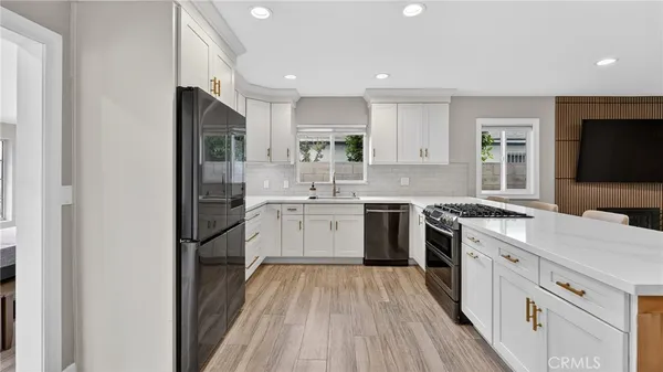 a kitchen with a sink stove and refrigerator