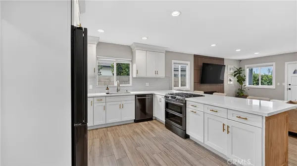a kitchen with a sink stove and cabinets