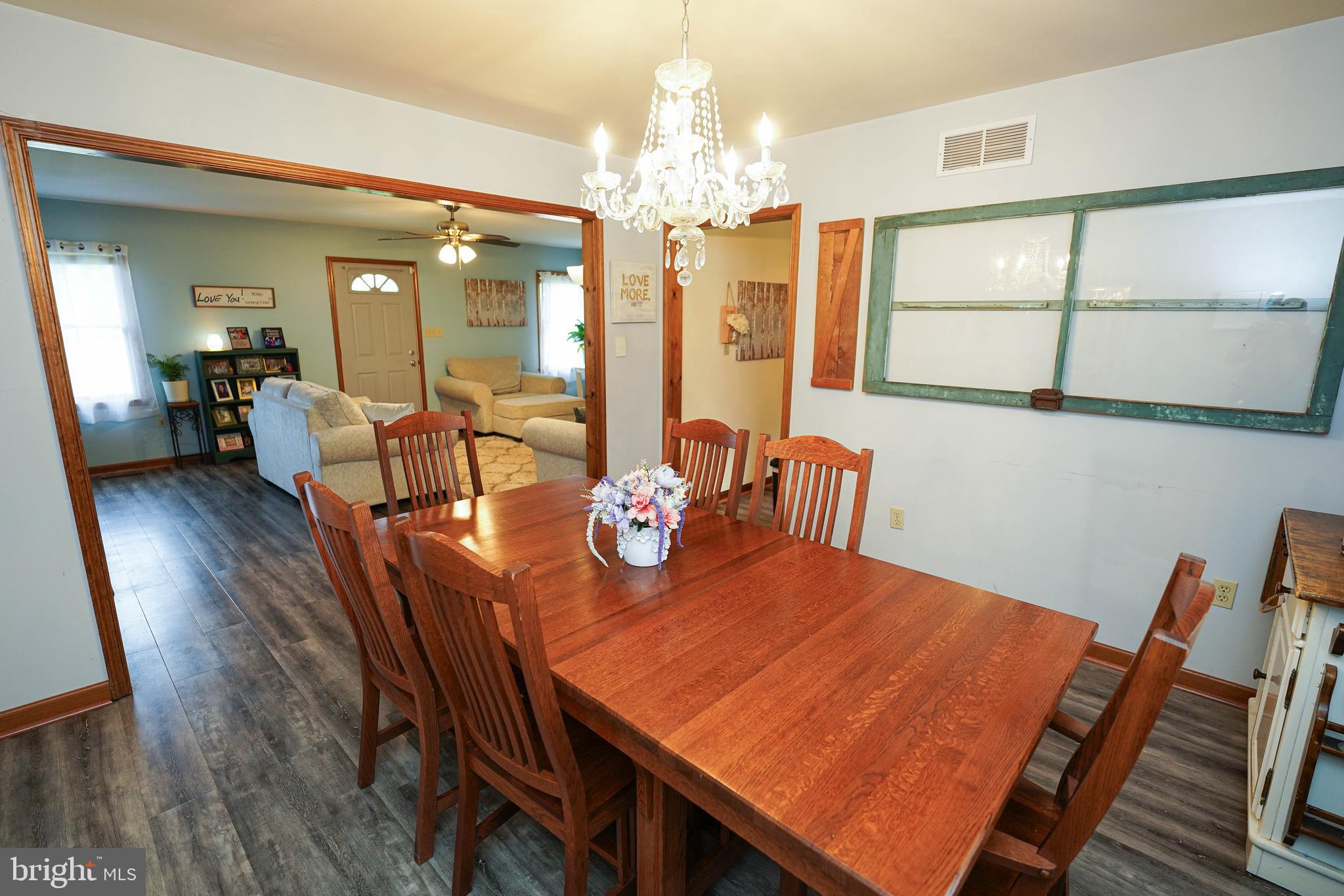 29325 West Line Road Delmar, MD 21875 - Photo 14 of 48 a view of a dining room with furniture a chandelier and wooden floor